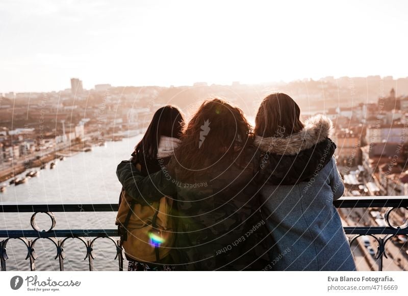 Three happy friends Porto bridge sightseeing at sunset. Travel, friendship and Lifestyle women city urban 30s travel together portuguese tour tourism woman