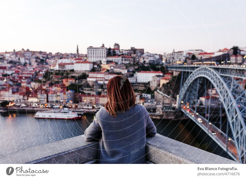 back view of relaxed woman in Porto bridge at sunset. Tourism in city Europe. travel and lifestyle porto tourist enjoy 30s holidays vacation urban high
