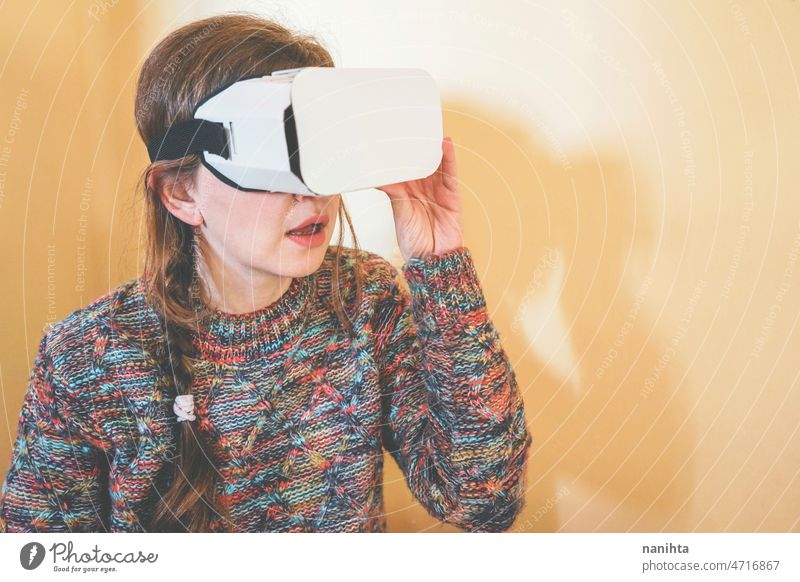 Spontaneous portrait of a young woman using cardboard vr glasses metaverse technology sustainability gamer virtual reality future progress concept surreal
