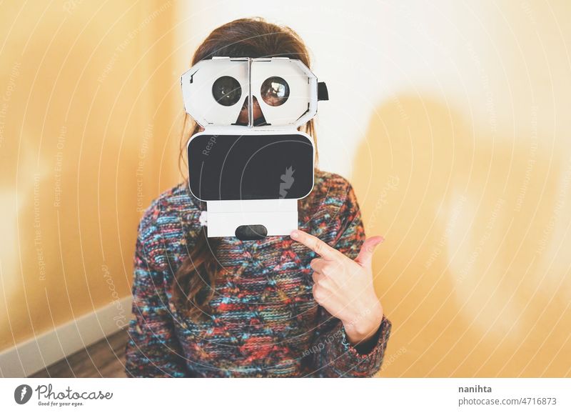 Image of a young woman showing the inside of a cardboard vr glasses metaverse lens technology sustainability playful gamer perspective weird nerd nerdy