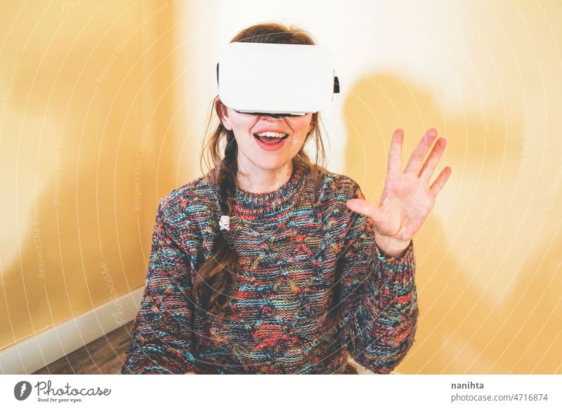 Spontaneous portrait of a young woman using cardboard vr glasses metaverse technology sustainability gamer virtual reality future progress concept surreal