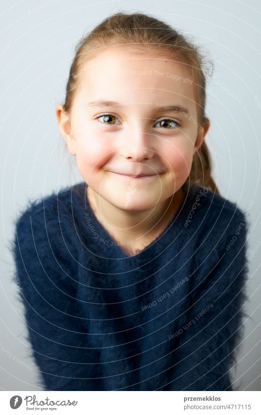 Portrait of adorable little girl. Cute small child looking at camera. Portrait of girl wearing blue sweater portrait cute person sweet smile happiness face