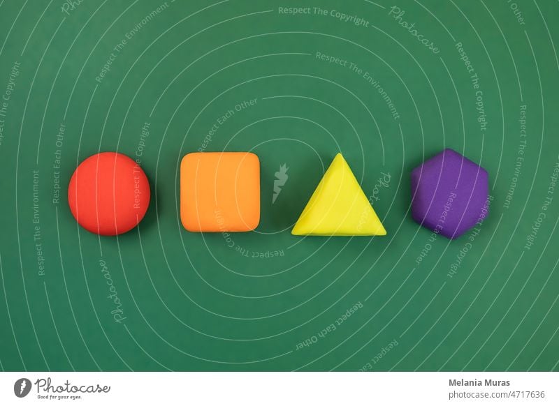 Geometric figures on green background. Colorful circle, square, hexagon and triangle shapes. Concept of diversity, creativity. 3d abstract activity attention