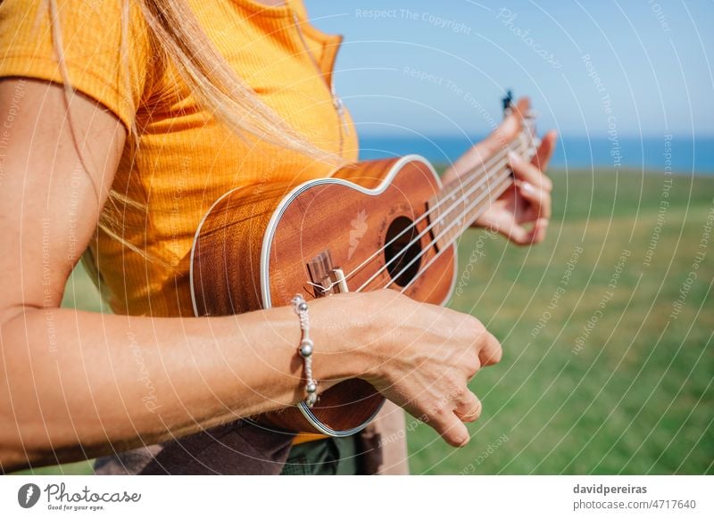 Unrecognizable woman playing the ukulele unrecognizable outdoors music musician musical instrument hand copy space relax hipster freedom song summer spring