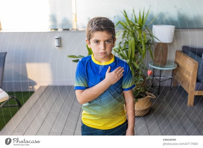 Little kid with a Ukraine t shirt pray for his country blue caucasian child conflict culture damaged history embroidered embroidery flag football freedom girl