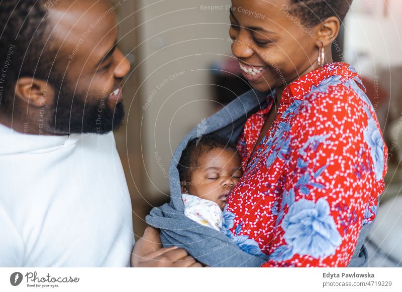 Young parents with their baby girl at home father mother kids child newborn family motherhood maternity real people indoors house flat apartment enjoy beauty