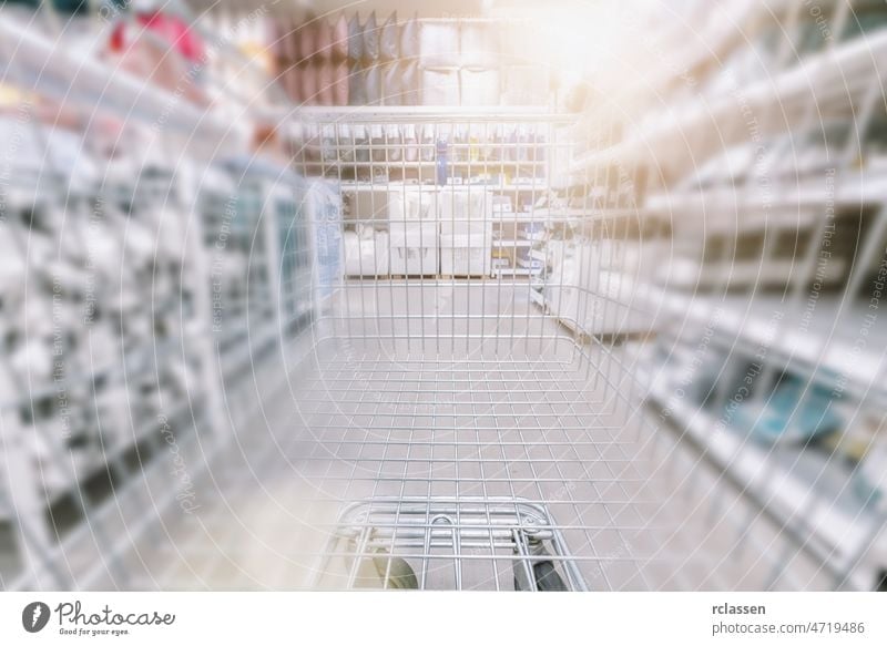 Shopping cart view in Supermarket aisle with product shelves abstract blur defocused background shop supermarket trolley grocery retail fast store business