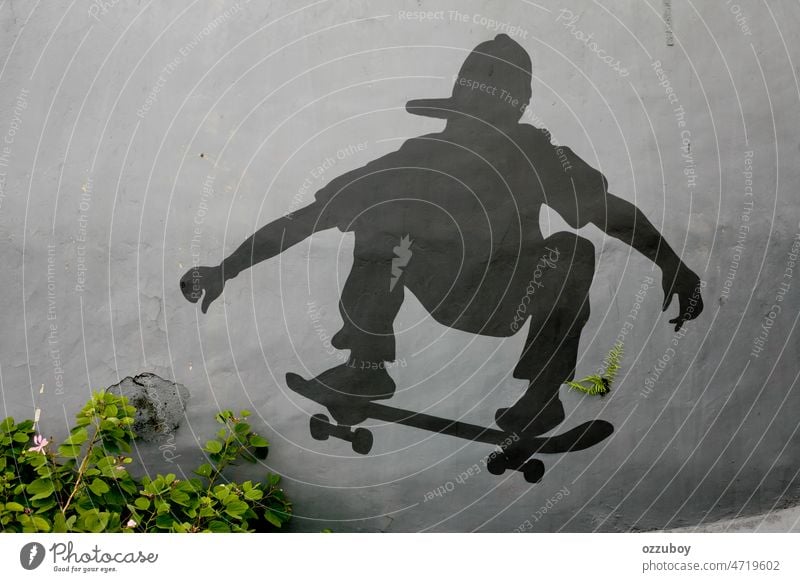 Black silhouette of a skater who is depicted with paints on the wall sport person skateboard skateboarding outdoor action trick youth extreme skateboarder