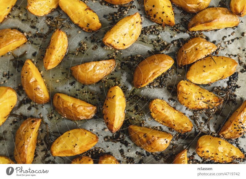 Baked potato wedges on baking tray meal fried homemade cooked spicy top baking paper view background bake oven chips closeup crispy cuisine delicious dinner
