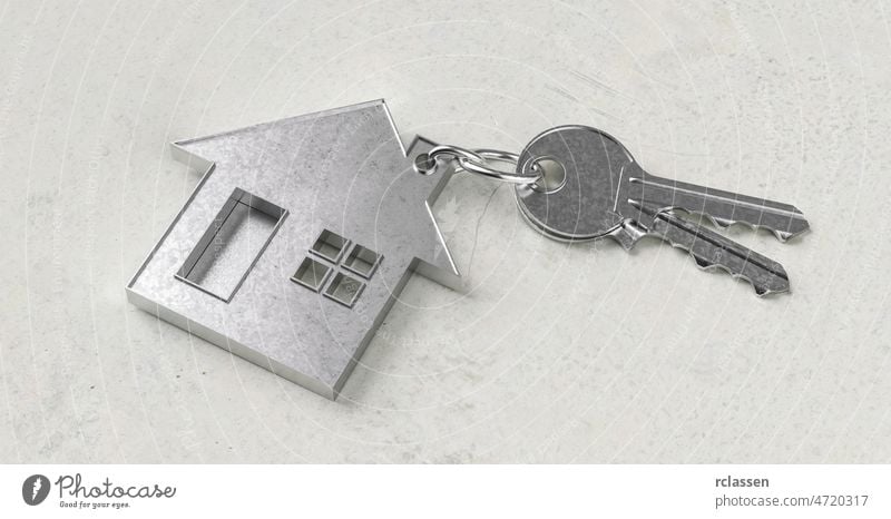 Keys with house shaped keychain on a concrete floor as a house purchase and housing concept property realtor market residential capital condo mortgage new