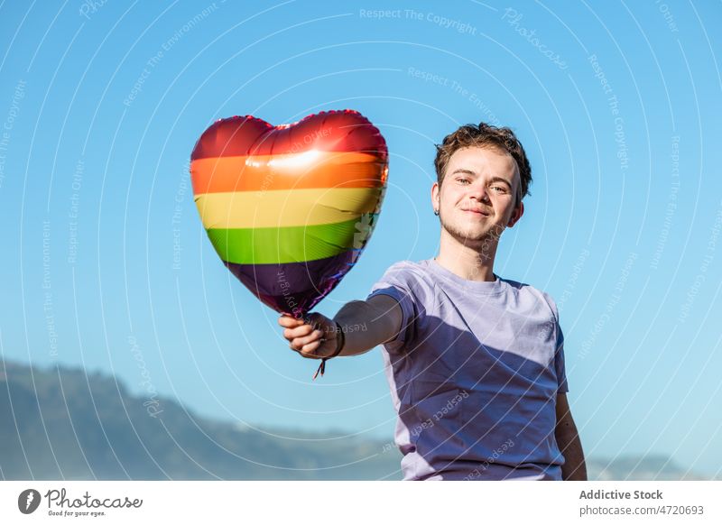 Cheerful man with LGBT balloon transgender lgbt lgbtq heart identity freedom equal gay homosexual pride tolerance symbol cheerful identify joy happy male