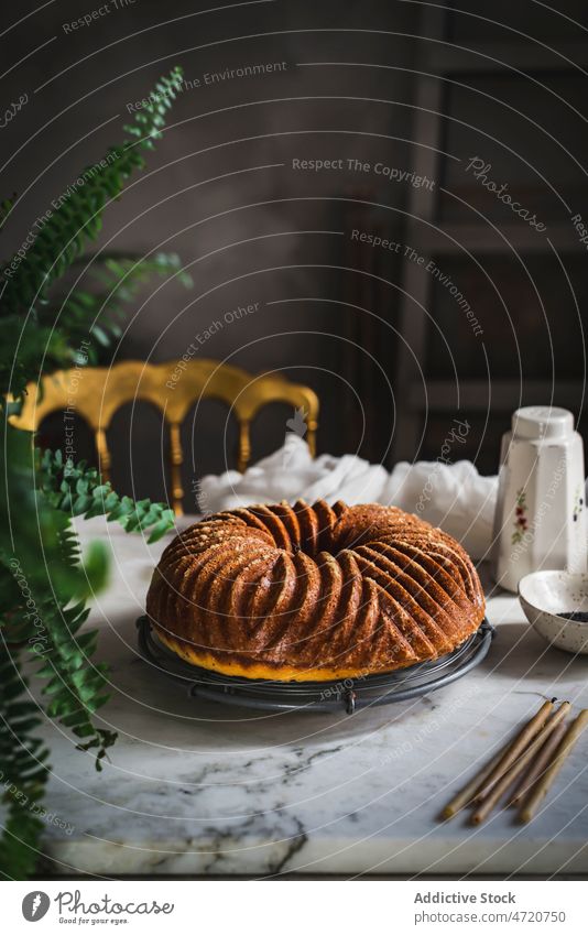 Appetizing sweet bundt cake on table in room kitchen candle dessert homemade delicious appetizing pie pastry food tasty yummy baked culinary palatable