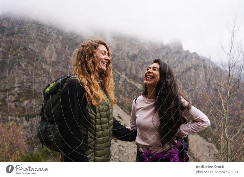 Laughing women in mountainous area friend bonding traveler hiker highland nature pastime having fun mood trekking friendship laugh adventure journey explore