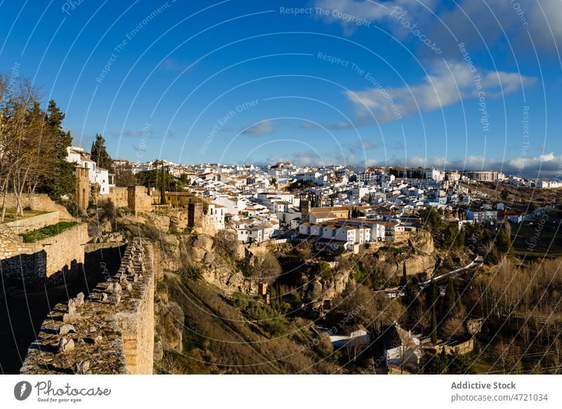 Old town with white houses and stone ruins at sunset fortress architecture sightseeing ancient historic heritage tourism landscape settlement landmark hill