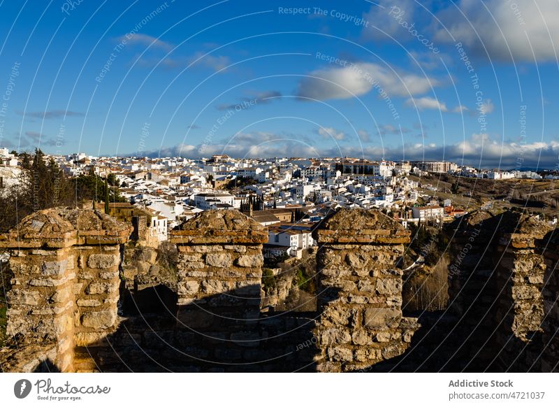 Old town with white houses and stone ruins at sunset fortress architecture sightseeing ancient historic heritage tourism landscape settlement landmark hill