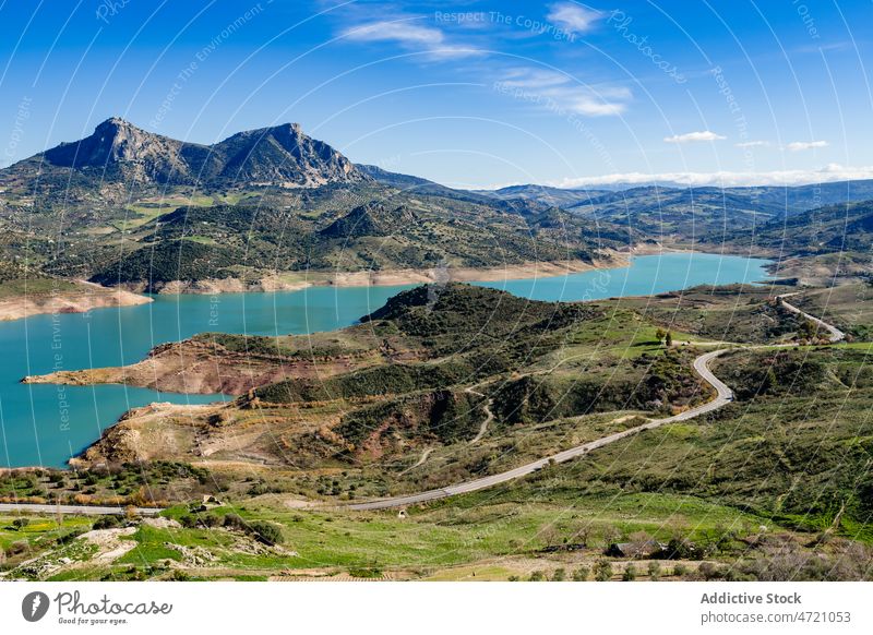 Scenic landscape of lake surrounded by mountains in Spain nature valley forest picturesque lakeside road ridge calm breathtaking water tree scenery range cadiz