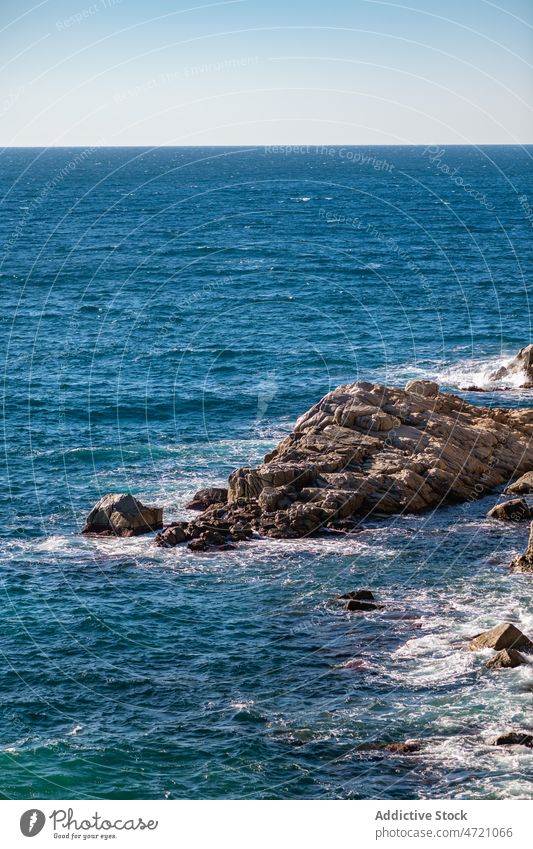Foamy waves of sea splashing on rocky shore in sunlight cliff seascape seashore nature picturesque ocean coastline power landscape breathtaking girona catalonia