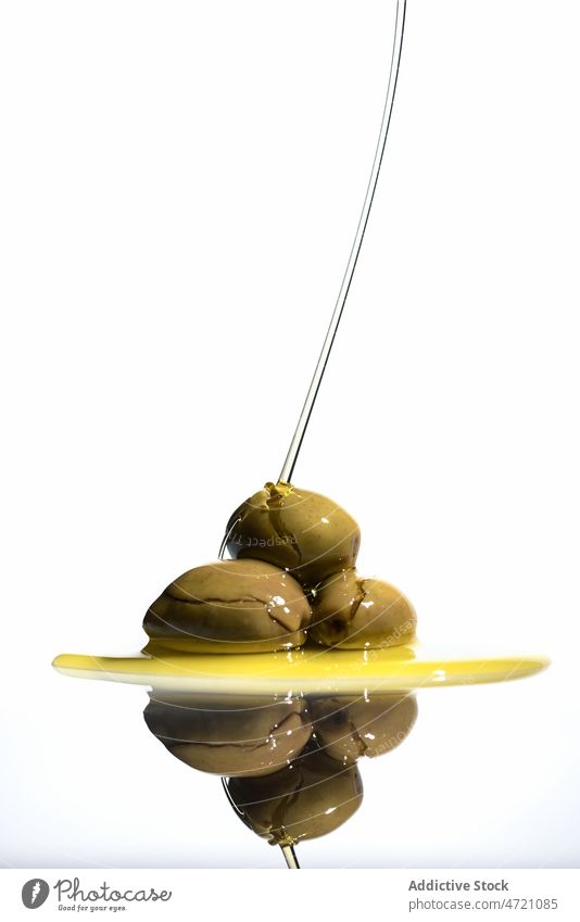 Green olives in light studio fruit oil fats organic natural green reflect vitamin healthy food table fresh room ingredient shape oval single style liquid