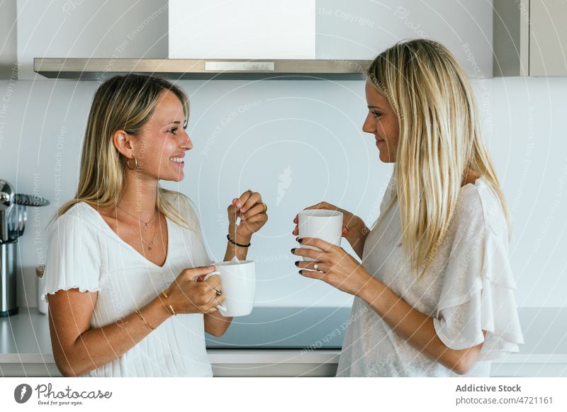 Women with coffee chatting in kitchen women friend bonding hot drink beverage style spend time refreshment taste cup female design at home domestic caffeine