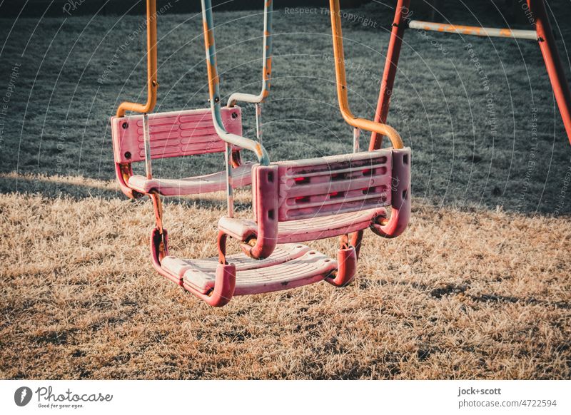 Winter, goodbye! Swing in ice and frost gondola Frost Sunlight Shadow Meadow children's toy Cold Deserted game device Loneliness Ice Double swing Framework