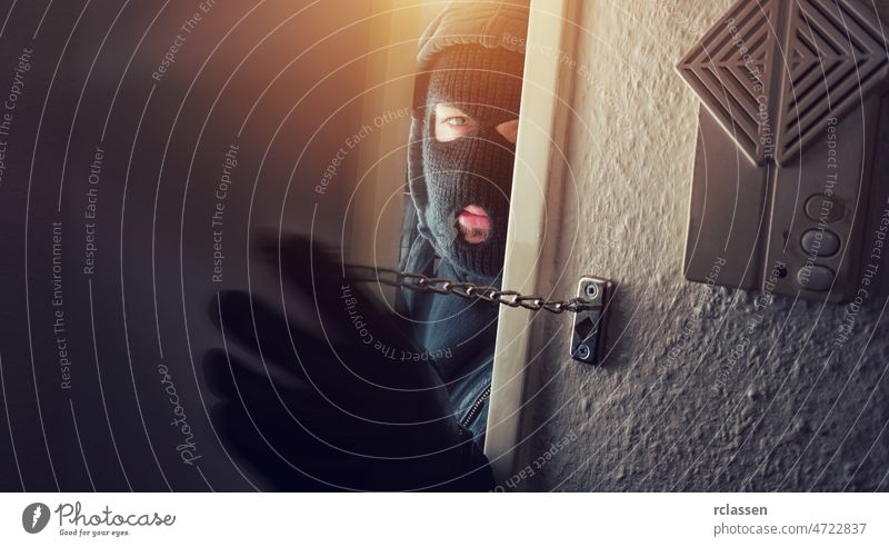 Burglar in mask at night burglar housebreaker theft alarm thief police burglary intruder criminal stealing illegal person safety gangster alarm system crack