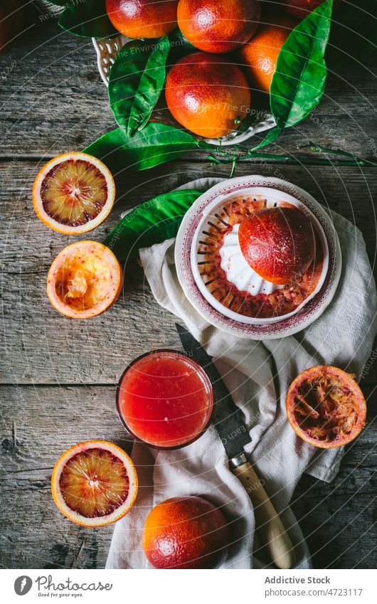 Heap of blood oranges with juicer citrus fruit vitamin kitchen equipment flavor table ripe fresh healthy wooden tasty delicious natural knife half refreshment