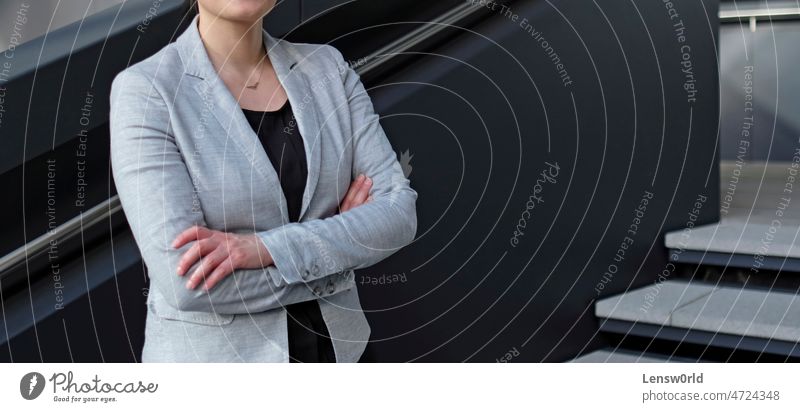 Businesswoman in a black shirt and grey suit jacket business business woman businesswoman corporate female female professional person urban woman in suit young