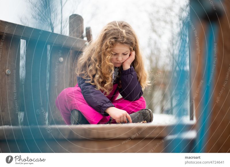 Girl on the playground in winter is sad Boredom boringly Winter corona Playing Playground Curl Mane feminine Snowsuit play alone Lonely Blonde Schoolchild chill