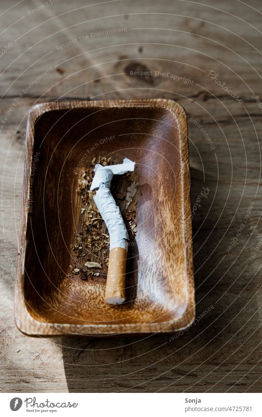 A broken cigarette in an ashtray. Cigarette shattered Broken Destruction Unhealthy peril Smoking Harmful to health Addiction Dependence Addictive behavior