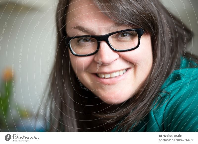 Woman with glasses smiling into the camera - Portrait portrait Young woman Adults Human being Face Smiling Joie de vivre (Vitality) Friendliness Contentment