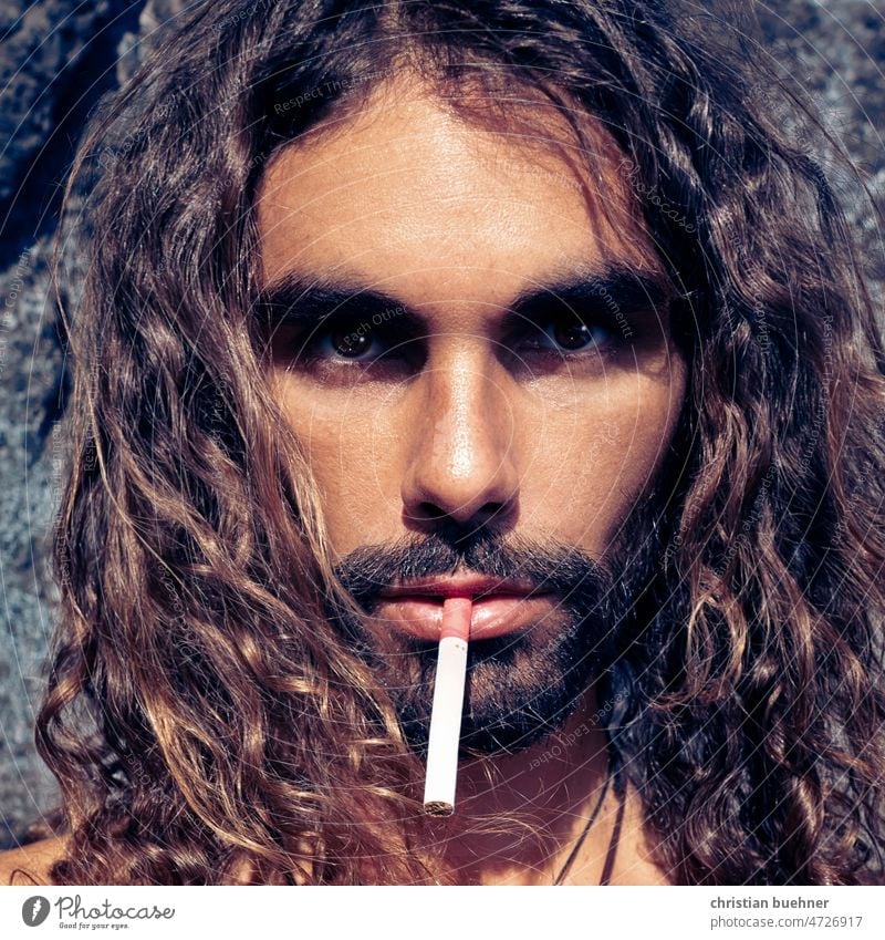 Portraits of 35 years old man with long hair and cigarette portrait Man Young man long hairs Curly hair Latin lover erotic Hippie self-sufficient Facial hair