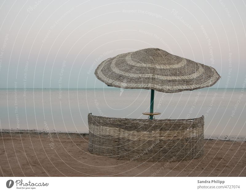 nartural parasol on the sandy beach directly by the sea Sunshade Beach Ocean Sand Vacation & Travel Summer Relaxation coast Sky Tourism Water Exterior shot Blue