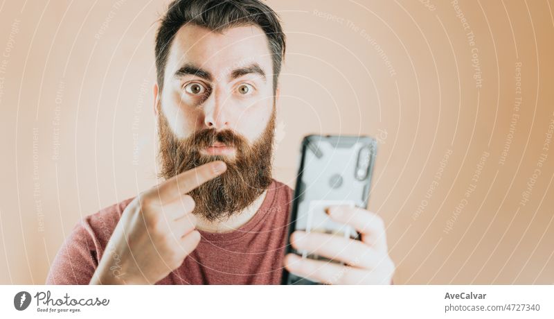 Mobile gadget dependence. Man bearded hipster play smartphone