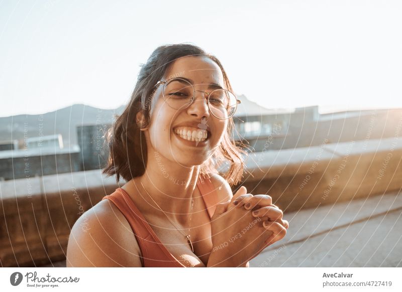 Portrait of young woman on sport clothes after a workout training outdoors, happy lifestyle sport. Portrait of happy fit people. Sport people workout concept during sunset, super smile and glasses