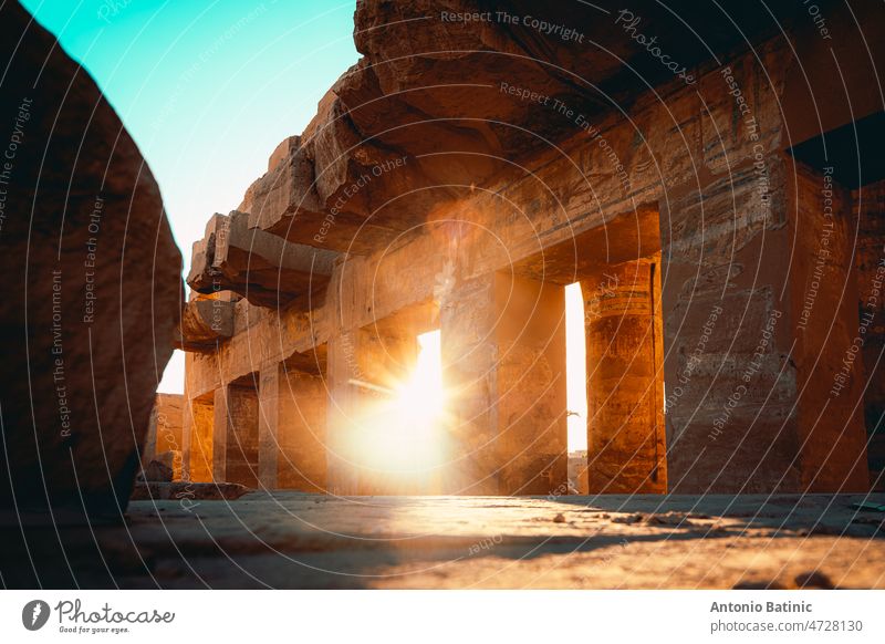 Aligned shot of ancient egyptian pillars in karnak temple in luxor, ancient temple open to public. Remains of the great egyptian civilization. Sun rays poking through the pillars
