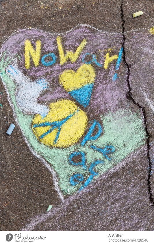 Lettering No War with Peace symbol and a dove for peace painted on asphalt with colored chalk Characters Solidarity Conflict Peace Declaration Hope for peace
