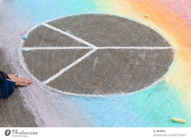 Peace symbol painted on asphalt with colored chalk peace Attachment Sign Friendship Prismatic colors Demonstration peace sign chalk writing Chalk drawing