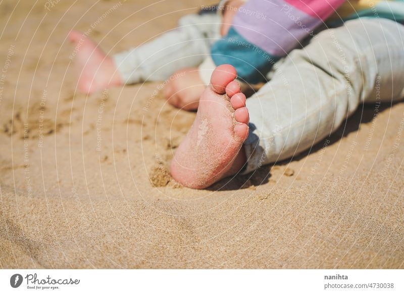 Close up of the feet of a toddler with sand of the beach foot baby beach close jeans delicate cute fragile play skin care sun sunny health healthy summer