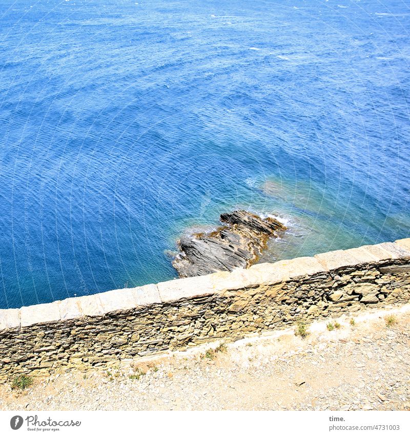 Looking beyond the horizon Wall (barrier) Water Rock off sunny warm Blue Mediterranean sea Waves wash round travel Deep Ocean coast Bay Surf Dry stone walling