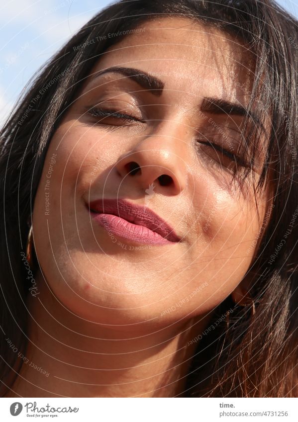 Woman enjoying the sun Smiling Closed eyes To enjoy close portrait Feminine Dark-haired Long-haired earring sunny warm