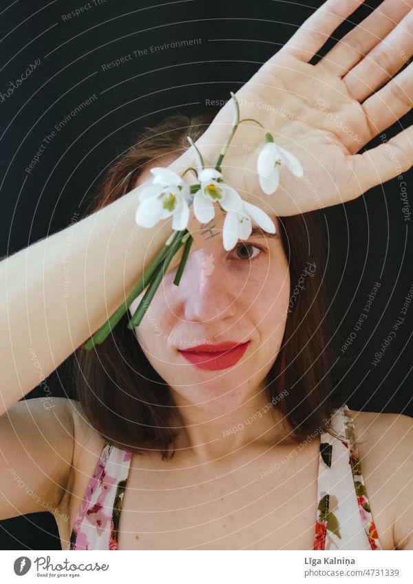 Woman with snowdrops on hand Youth (Young adults) young woman Human being Portrait photograph Young woman Adults 18 - 30 years Beautiful Feminine Head Face