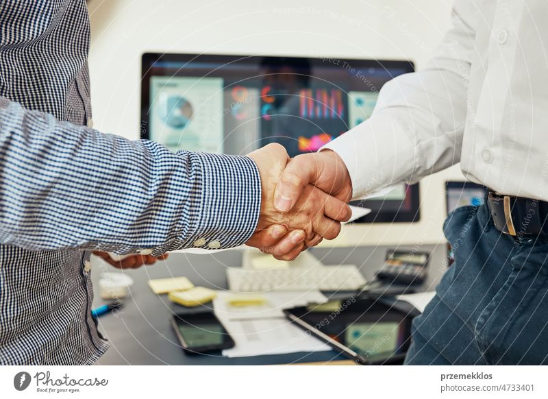 Handshake of business people. Man and woman shaking hands in office. Two people greeting at work. Collaborative teamwork person handshake meeting businessman