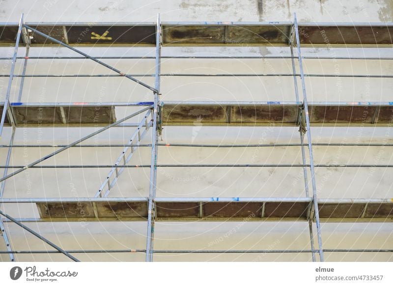 Scaffolding with ladder on a building / renovation / modernization / construction site refurbishment Redecorate conversion Ladder Metal Metal conductor Plaster