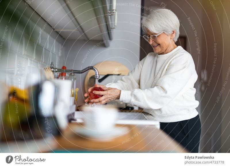 Shot of a senior woman in her kitchen Active Seniors Kitchen Sink kitchen counter Preparation water chores housework alone at home domestic life elderly female