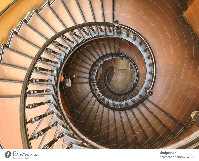 Top view of a spiral staircase in an old building Winding staircase Stairs plan Bird's-eye view Woman Crumpet Old building Staircase (Hallway)