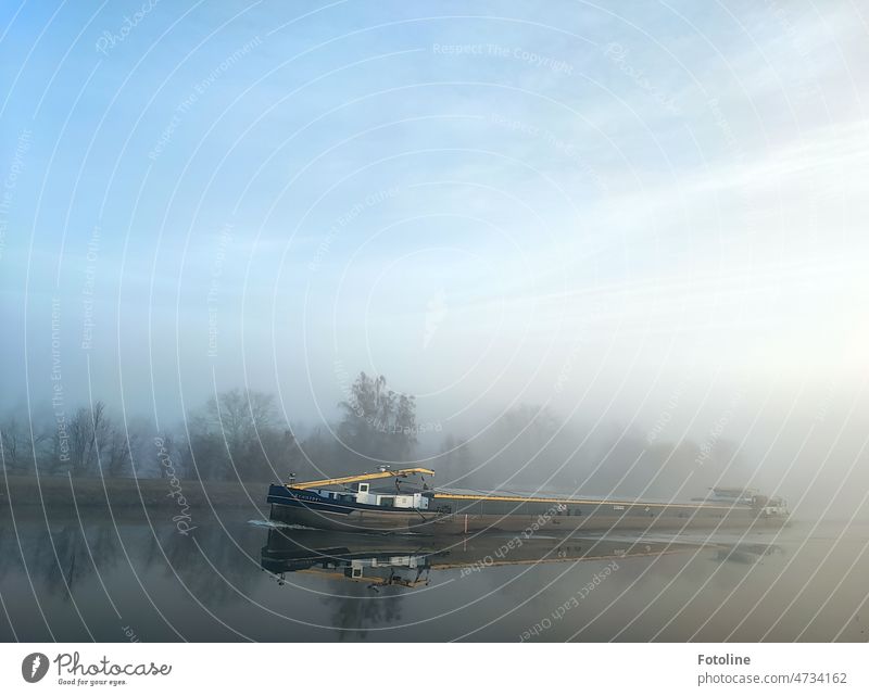 In the morning on the Mittellandkanal, a ship emerges from the fog on the mirror-smooth water surface. Water Navigation Watercraft Exterior shot Colour photo