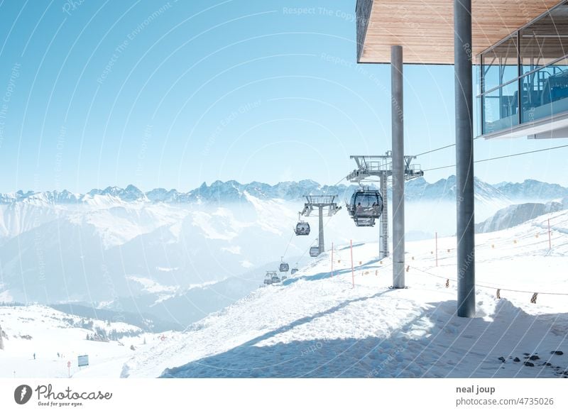 Summit station of a gondola with a view of a snow-covered alpine panorama Landscape Alps mountain Peak Winter Snow White Blue Far-off places Winter sports