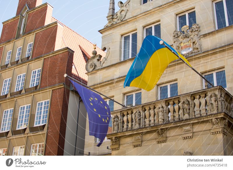 The Ukrainian and European flags fly at the Stadtweinhaus in Münster in Westphalia, Germany Ukraine Flags Ukraine war Ensign Sign Peace Building