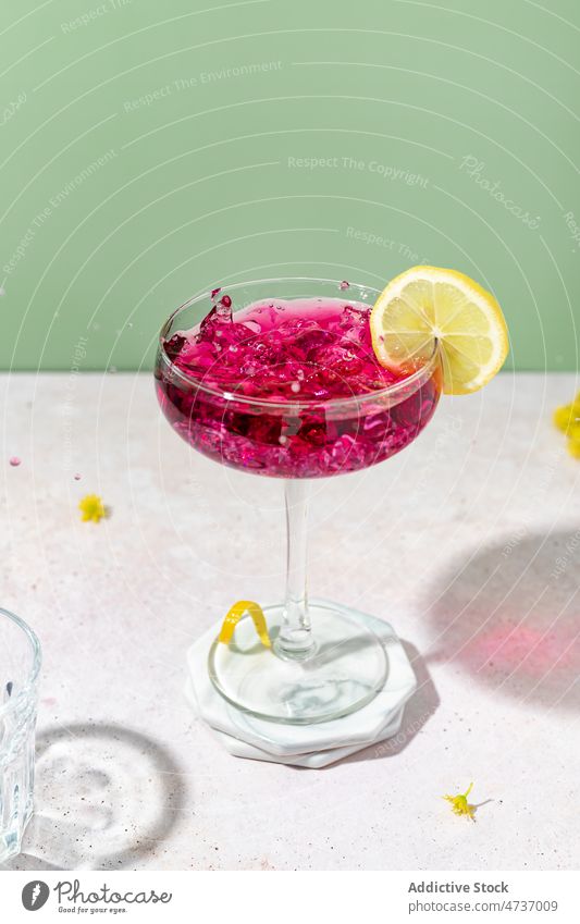 Glass with sweet blackberry liqueur on table serve glass style cold lemon alcohol ice elegant glassware citrus tasty studio shot aperitif frozen transparent