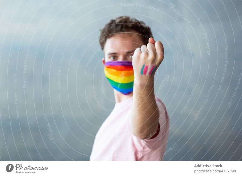 Man in LGBT medical mask man transgender lgbt pandemic symbol identity unconventional safety equal respect activism rainbow coronavirus new normal covid 19
